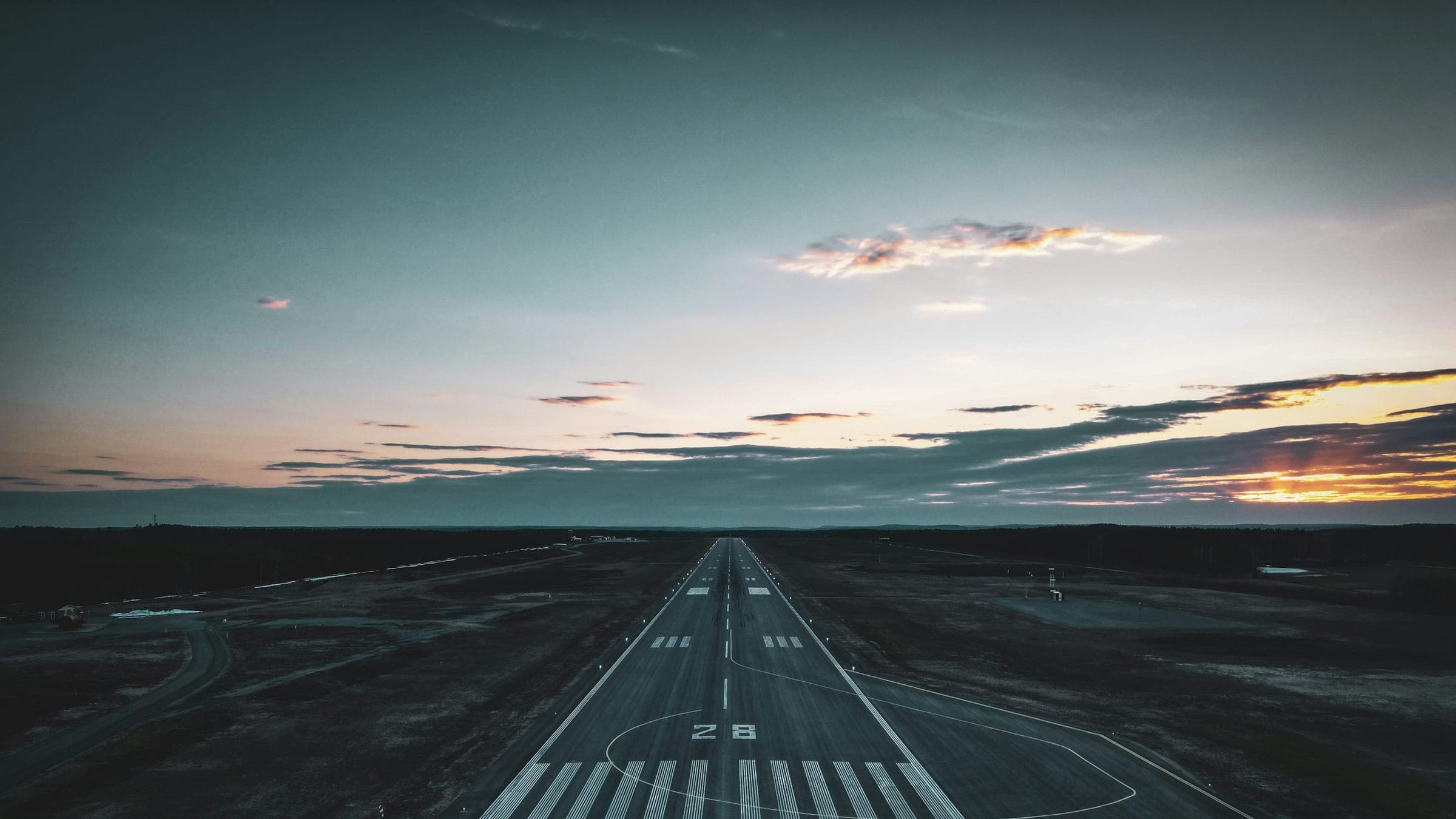 Private jet on the runway at dusk — illustrative